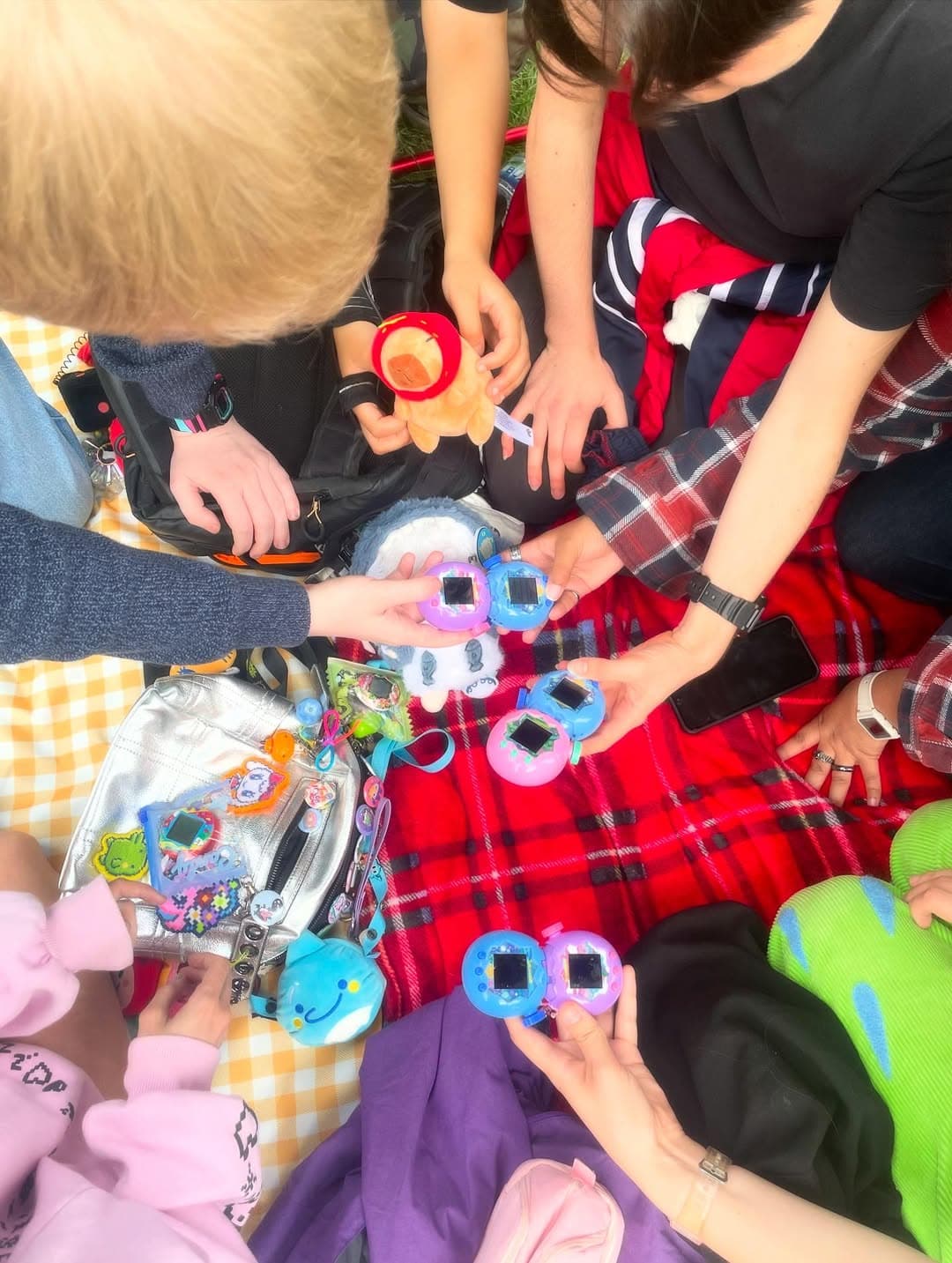 Several people connecting Tamagotchi Paradise devices